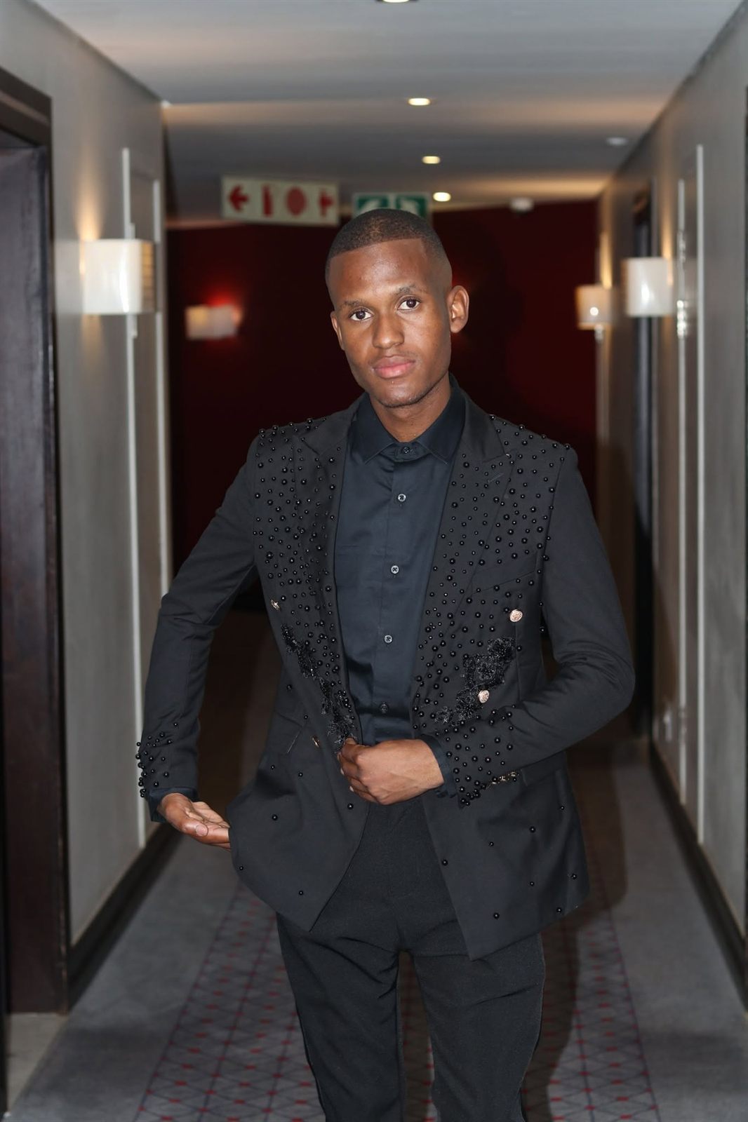 Indoor portrait of a man in a black beaded suit