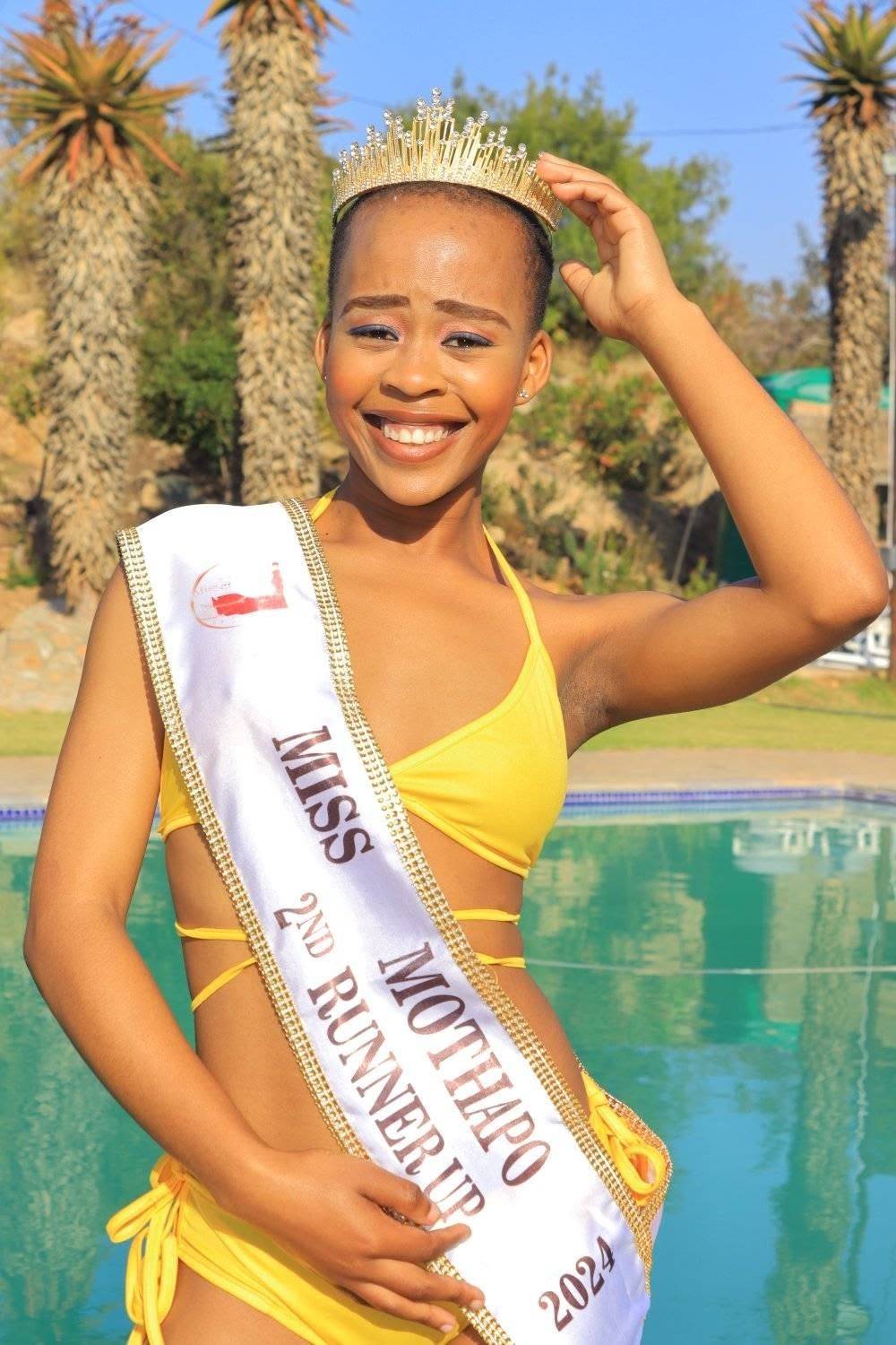 A pageant contestant in yellow at an outdoor event